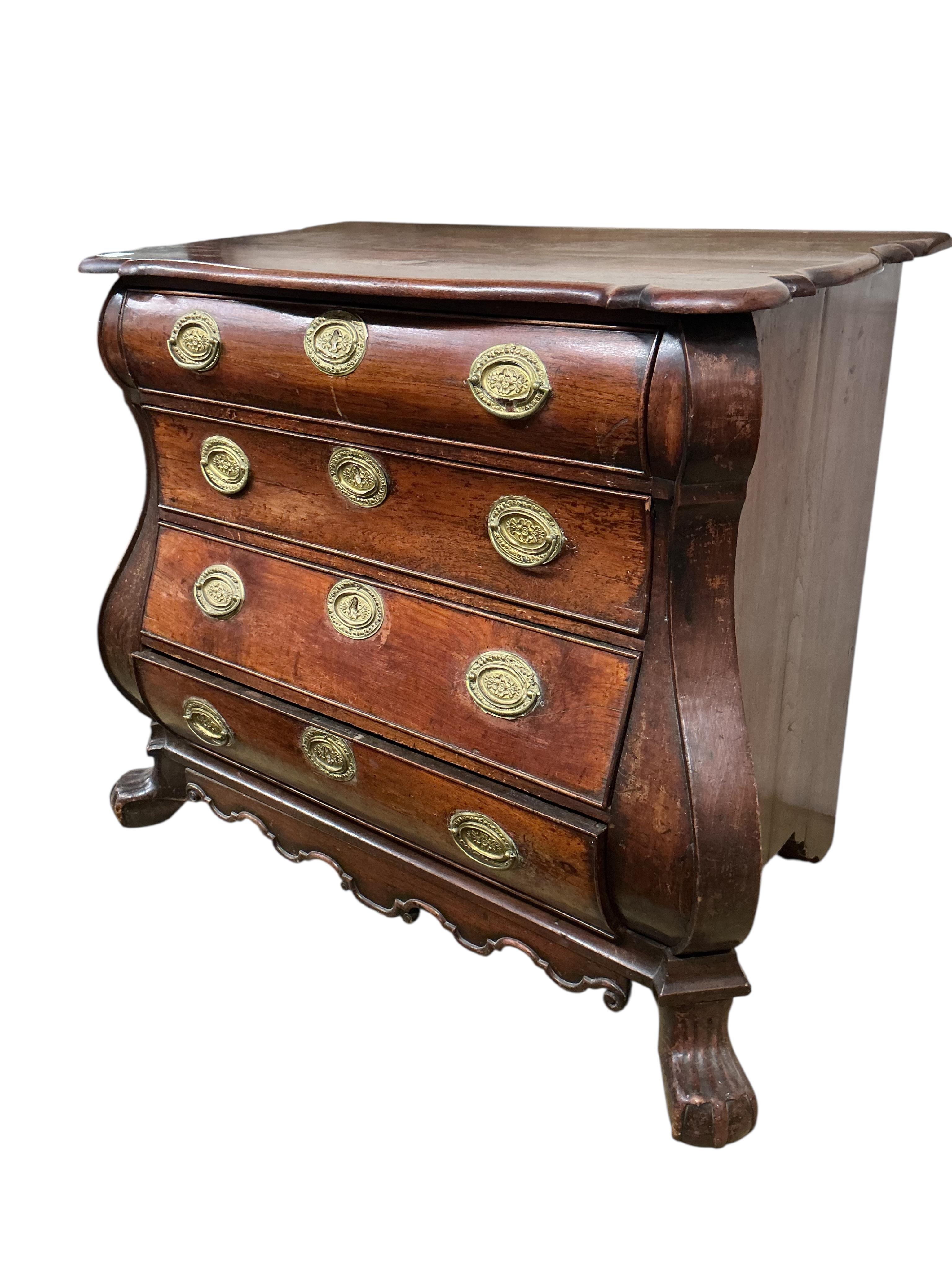 An 18th century Dutch oak bombe chest, of four long drawers, width 106cm, depth 54cm, height 87cm